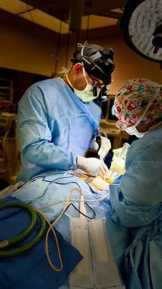 Brandon A. Ortega, MD performing spine surgery